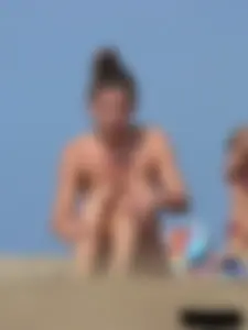 Sexy babe with a nice body topless and in a thong on the beach