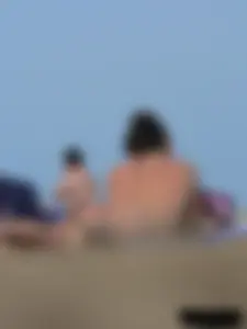Sexy babe with a nice body topless and in a thong on the beach