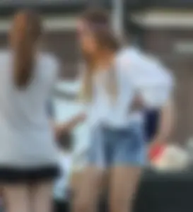 Hippie type dressed girl in denim shorts with a nice ass