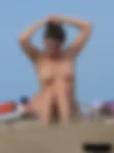 Sexy babe with a nice body topless and in a thong on the beach