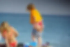 Hot blonde with a slammin body in red thong bikini on the beach