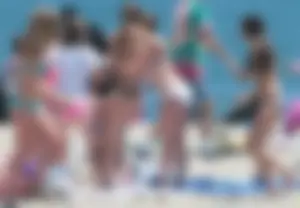 Bunch of sexy babes at the beach in bikinis