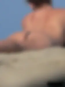 Sexy babe with a nice body topless and in a thong on the beach