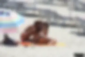 Topless milf and her topless daughter on the beach