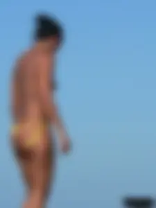 Bunch of sexy babes on the beach topless and in thong bikinis