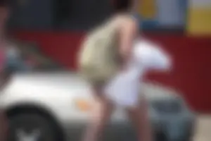 Trio of girls in bikinis on the beach and one with an incredible ass