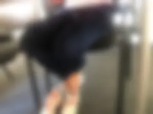 Crossed Legs in Velvet Pants and Feet in Socks Under Table Creepshot