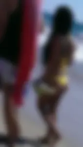 Beach babe with a nice ass and big tits in yellow thong bikini