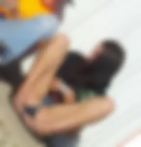 Girl with No Panties Under Denim Shorts Sitting on the Ground with Spread Legs in Slippers