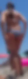Girls hanging out together at the beach in bikinis and thongs
