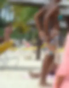 Sexy black babe in various bikinis on the beach while on vacation
