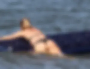 Black thong bikini blonde with a nice ass out on a tube in the water