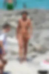 Older lady on a nude beach showing her body