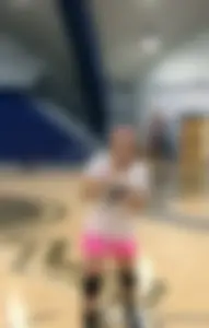 Bunch of cute college girls in bright pink shorts playing volleyball