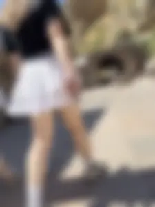 Closeups of a hot girl’s pale legs, she’s wearing a skirt