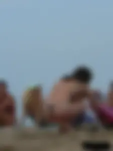 Sexy babe with a nice body topless and in a thong on the beach