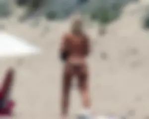 Small boobed topless milf on the beach