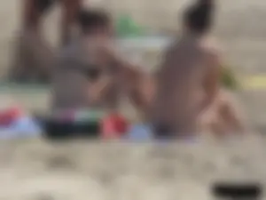 Sexy babe with a nice body topless and in a thong on the beach