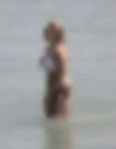 Big boobed thick blonde on the beach in a bikini