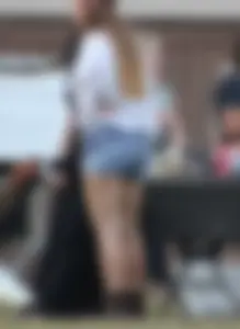 Hippie type dressed girl in denim shorts with a nice ass
