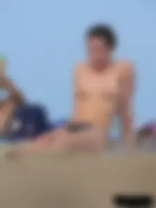 Sexy babe with a nice body topless and in a thong on the beach