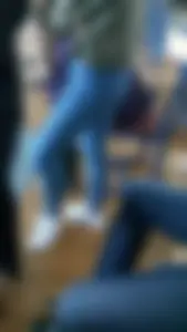 College teen wearing tight blue jeans in class