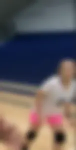 Bunch of cute college girls in bright pink shorts playing volleyball