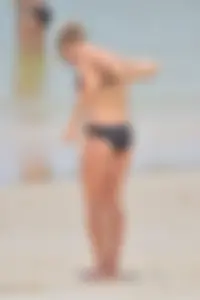 Sexy chick in red and black bikini on the beach