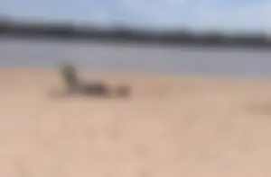 Girl laying out getting sun in a white thong bikini