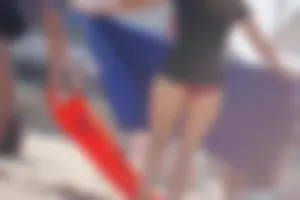 A group of teens in bikinis on the beach