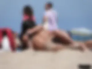 Topless lady on the beach in a gold thong with a nice ass
