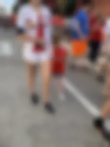 Bunch of girls in various outfits at a Cardinals baseball game