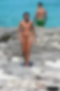 Older lady on a nude beach showing her body