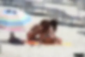 Topless milf and her topless daughter on the beach