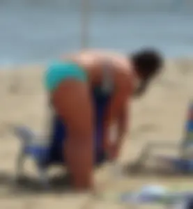 Thick beach girl in a teal bikini