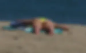 Sexy ass blonde milf on the beach in a thong with cameltoe and bending over