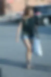 Cutie walking in the parking lot in jean shorts