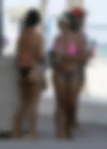 Latina milfs on a beach in Florida in thong bikinis with big booties