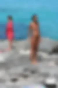 Older lady on a nude beach showing her body