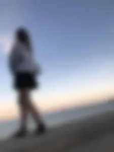 Girl in a skirt creepshot by the sea