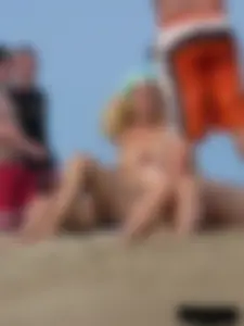 Sexy babe with a nice body topless and in a thong on the beach