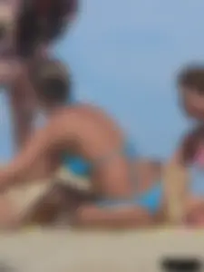Sexy lady on the beach in a blue thong bikini