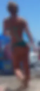 Sexy blonde on the beach in a teal thong bikini with nice ass