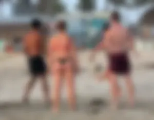 Thick white girls ass in a black thong bikini at the beach