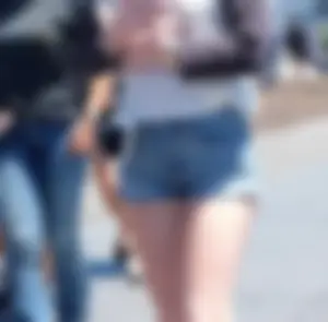 Cute girl walking in short jean shorts