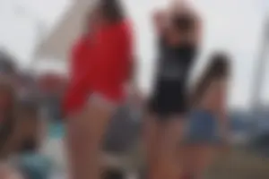 A group of teens in bikinis on the beach