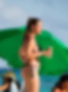 A few sexy girls with great asses in thong bikinis at the beach