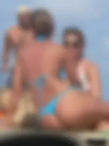 Sexy lady on the beach in a blue thong bikini