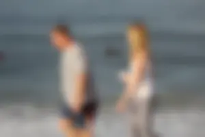 Skinny blonde on the beach in tight grey leggings