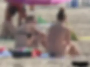 Sexy babe with a nice body topless and in a thong on the beach